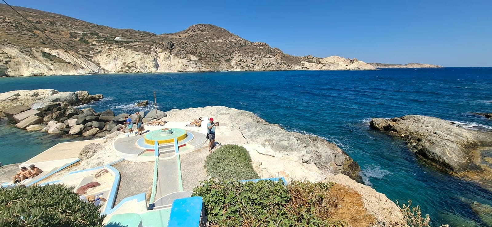 Colourful swimming platform on the rocks at Firopotamos cove, Milos