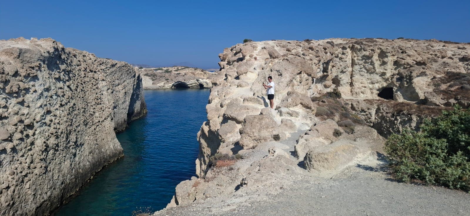 Narrow sea channel between the limestone walls of Papafragas caves, Milos