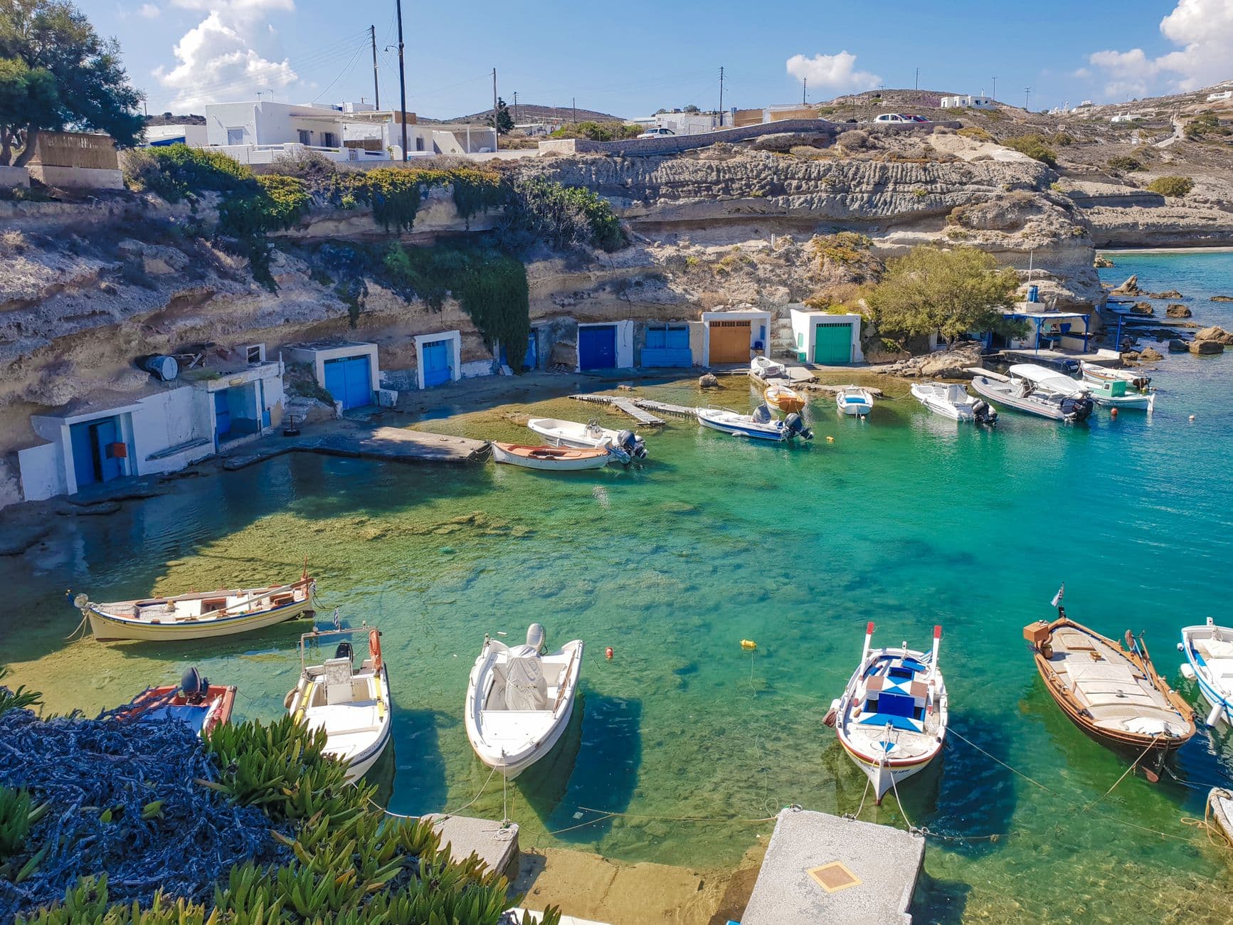 Traditional fishing harbour with boats on Milos on a sunny day