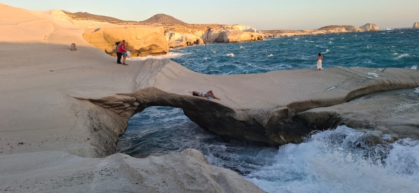 Natural rock arch over breaking waves at Sarakiniko beach, Milos